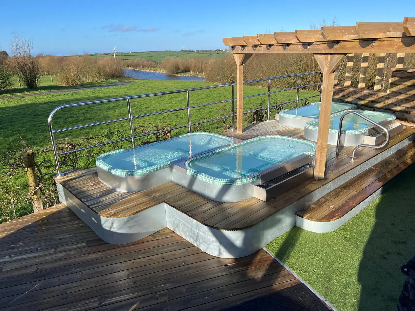 Hot tubs, sauna and cold plunge experience overlooking Cornish countryside at Little Pig Wellness near Bude. This is part of a 2-night wellness escape.