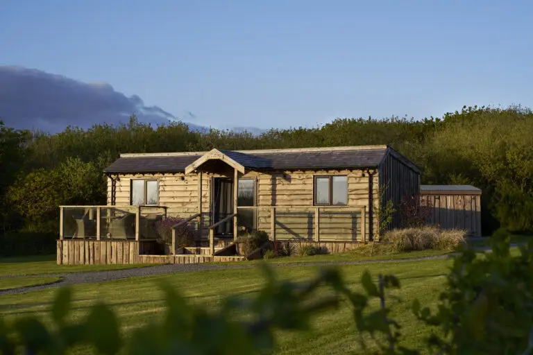 Luxury self-catering lodge surrounded by countryside at Little Pig Wellness near Bude, North Cornwall.